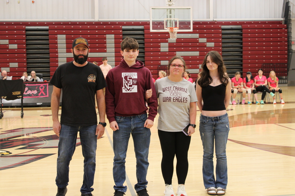 A West Carroll senior athlete stands with family members on the court during Senior Night festivities.