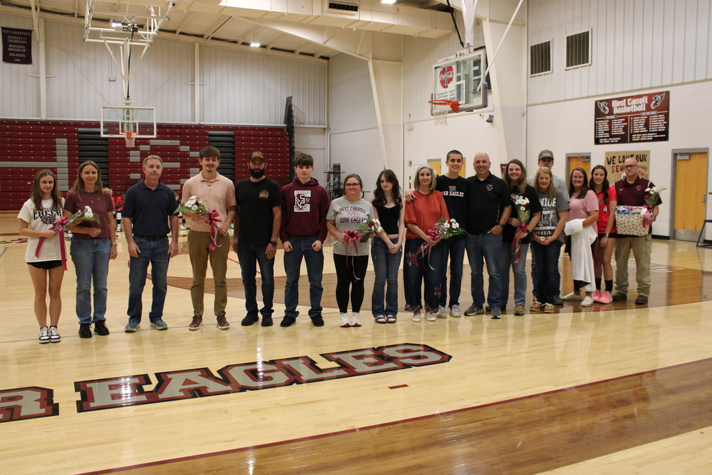 West Carroll senior athletes and their families line the court during Senior Night recognition for volleyball, golf, and cross country.