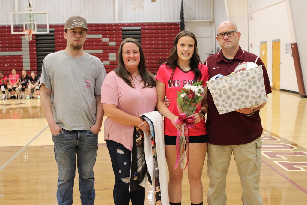 A West Carroll senior athlete stands with family members on the court during Senior Night festivities.