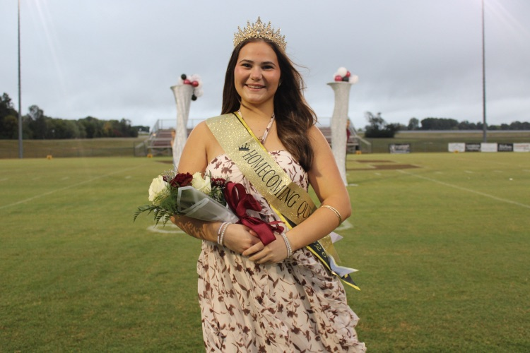 Homecoming Queen: 2026 West Carroll Football Homecoming Queen Taytum Jenkins smiles on the football field wearing her crown and sash and holding a bouquet of flowers.