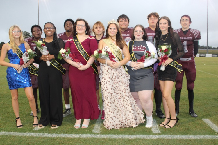 Court & Escorts: The 2026 West Carroll Football Homecoming Court poses with their escorts, who are dressed in War Eagle football uniforms.