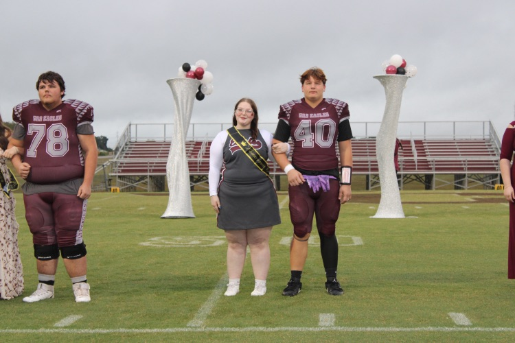 Summer Spain: Senior Homecoming representative Summer Spain stands on the football field with her escort, Cole Mueller.
