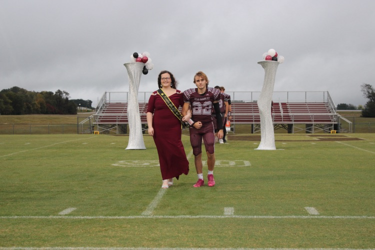 Jada Bradshaw: Senior Homecoming representative Jada Bradshaw walks onto the field with her escort, R Q Thompson.