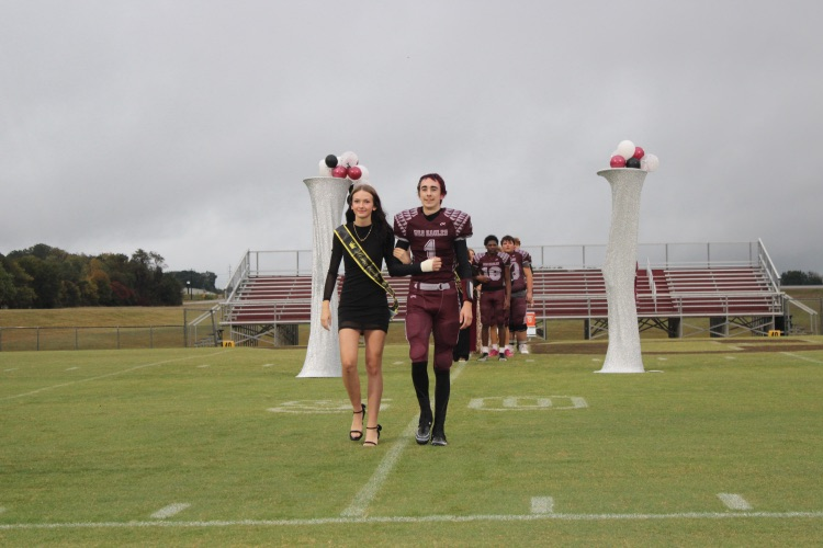 Kinsley Poff: Sophomore Homecoming representative Kinsley Poff walks onto the field with her escort, Briggs West.