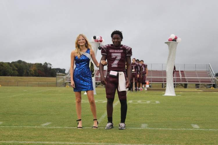 April Shumate: Freshman Homecoming representative April Shumate poses on the field with her escort, Chris Pruitt.