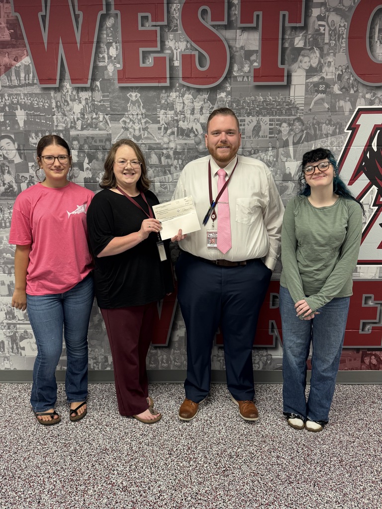 Dr. Adam Douglas pictured with librarian, Sally Arnold, and two students
