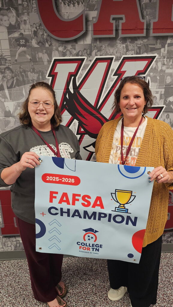 Two West Carroll staff members hold a 2025-2026 FAFSA Champion banner from College for TN. The recognition celebrates West Carroll Jr./Sr. High School’s success in FAFSA completion among Tennessee Promise applicants.
