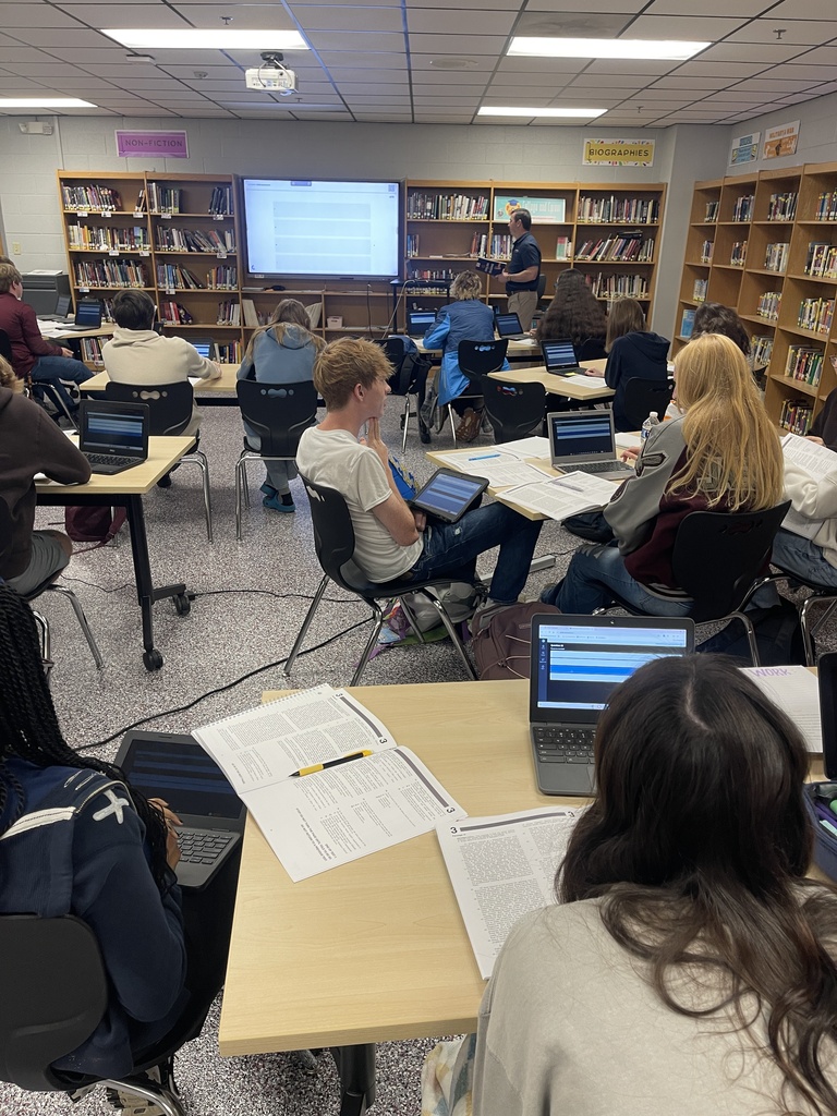 West Carroll juniors and seniors participate in an ACT Bootcamp in the school library. Students work at tables with laptops and ACT practice materials while an instructor leads the session from the front of the room.