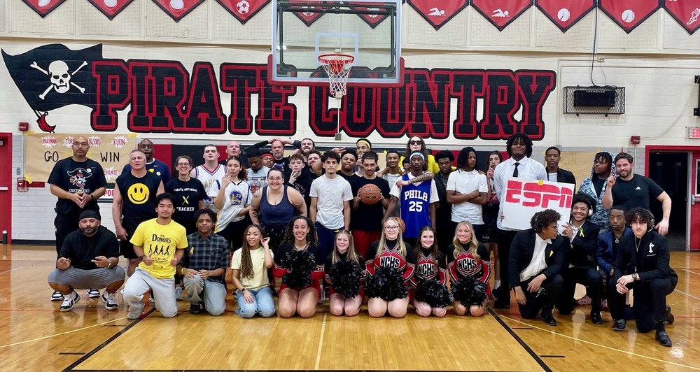 Students and staff on the basketball court