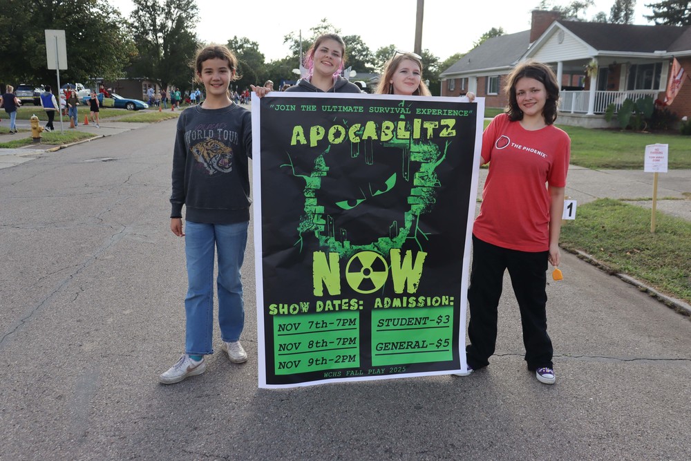 four girls holding sign for fall play