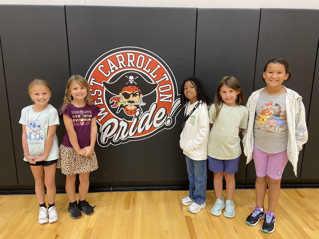 Five students in front of West Carrollton Pirate Pride Sign