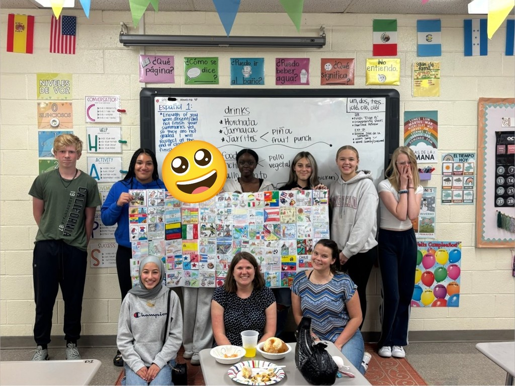 A group of students holding a poster