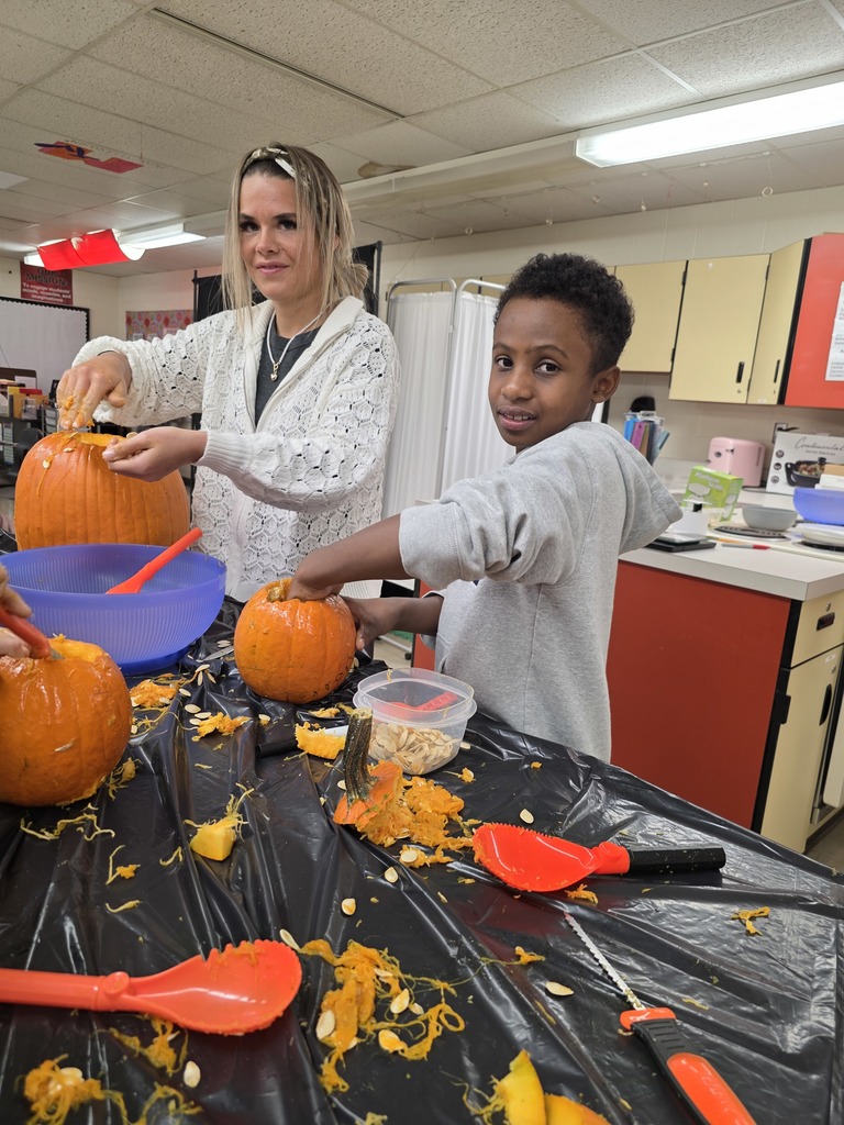 Student carving a pumpkin