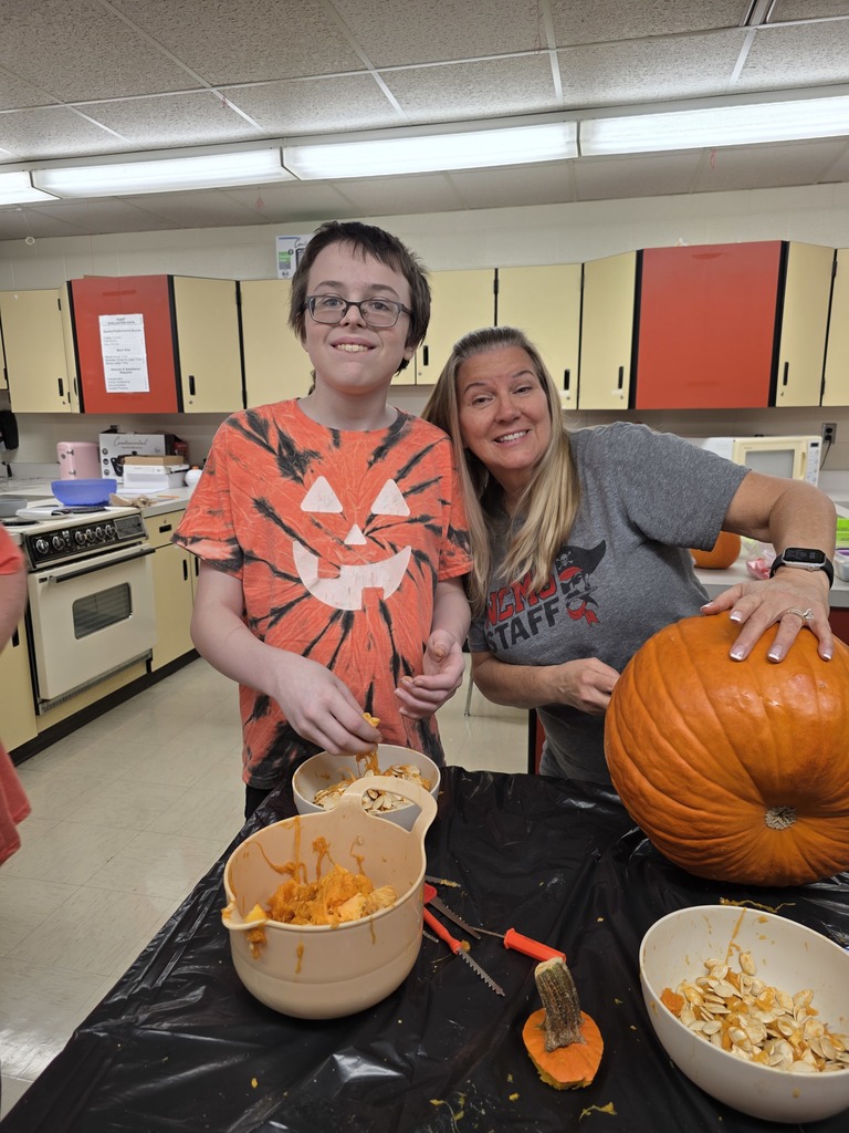 Student carving a pumpkin