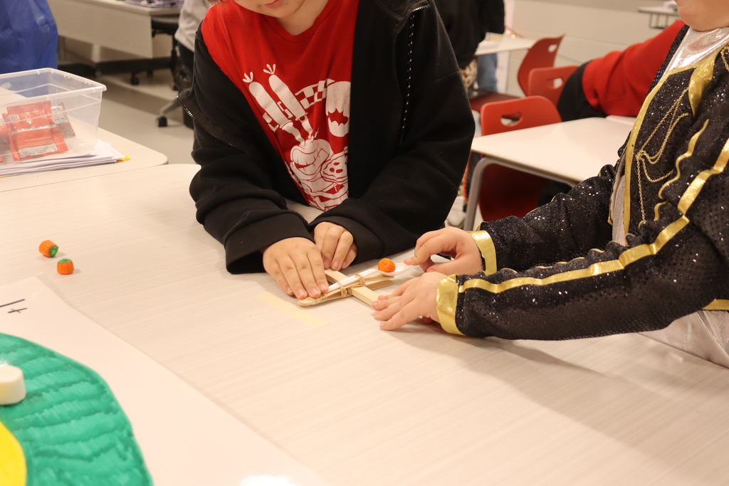 kids catapulting candy onto target