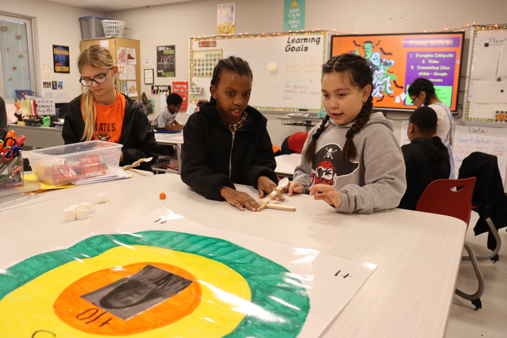 kids catapulting candy onto target
