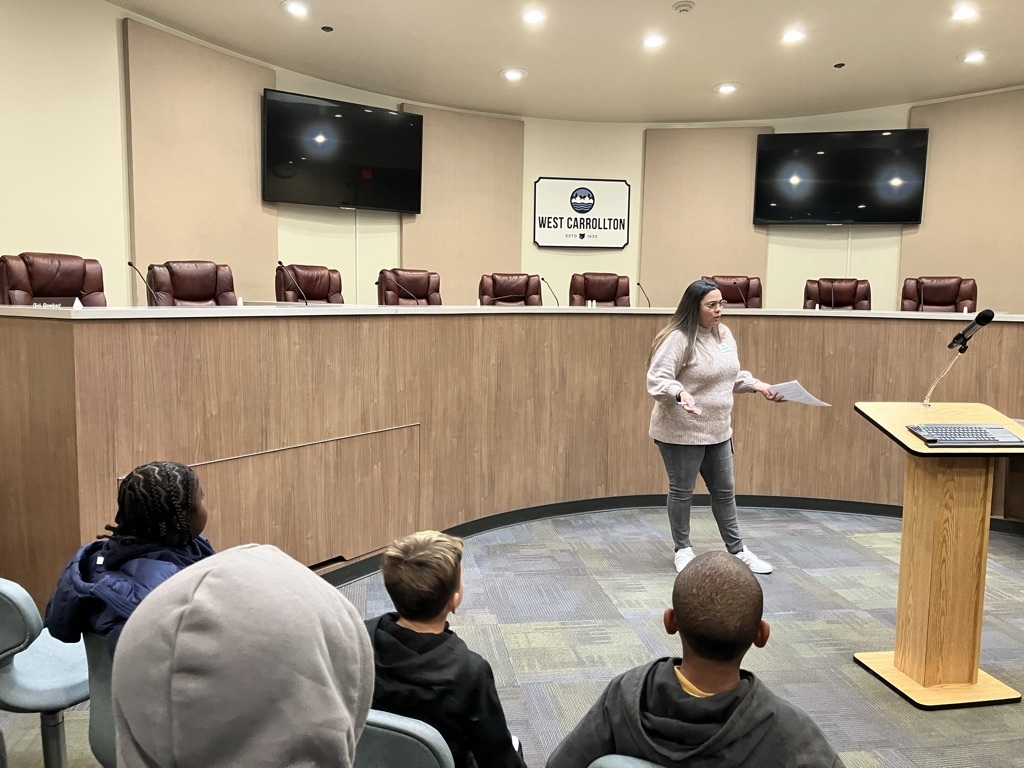a woman speaking in a conference room
