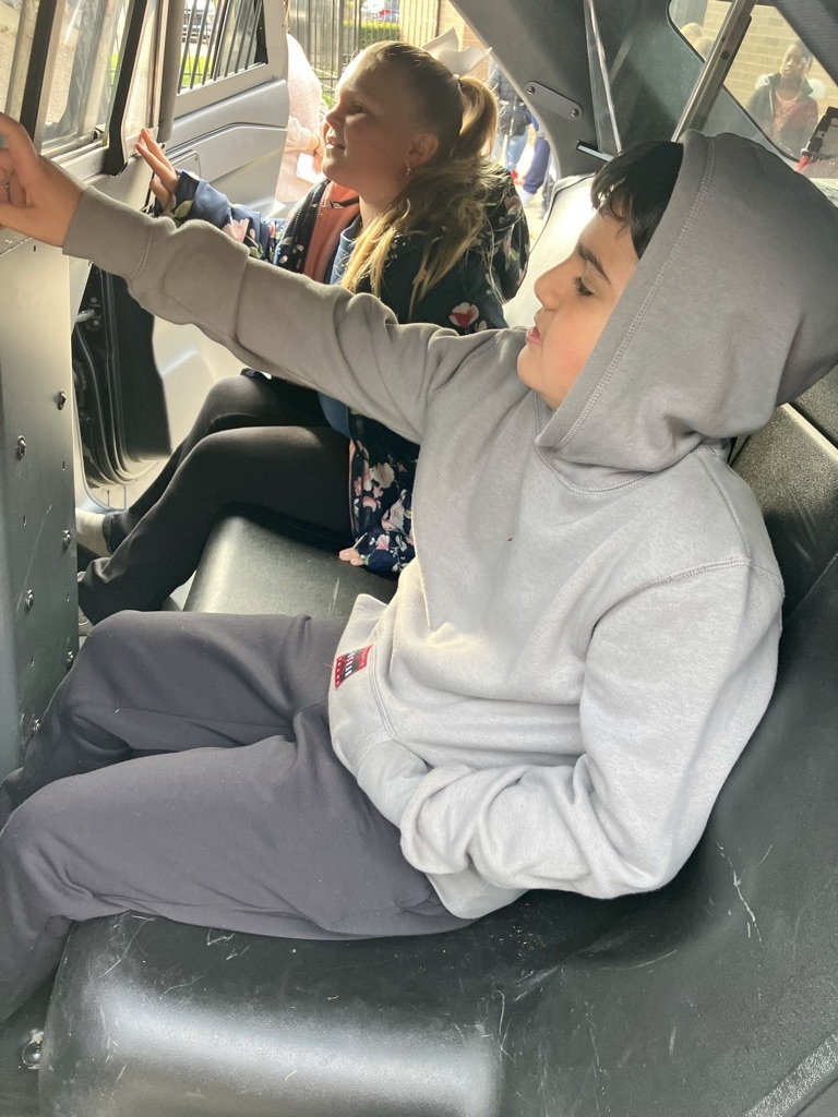 two kids in an emergency vehicle