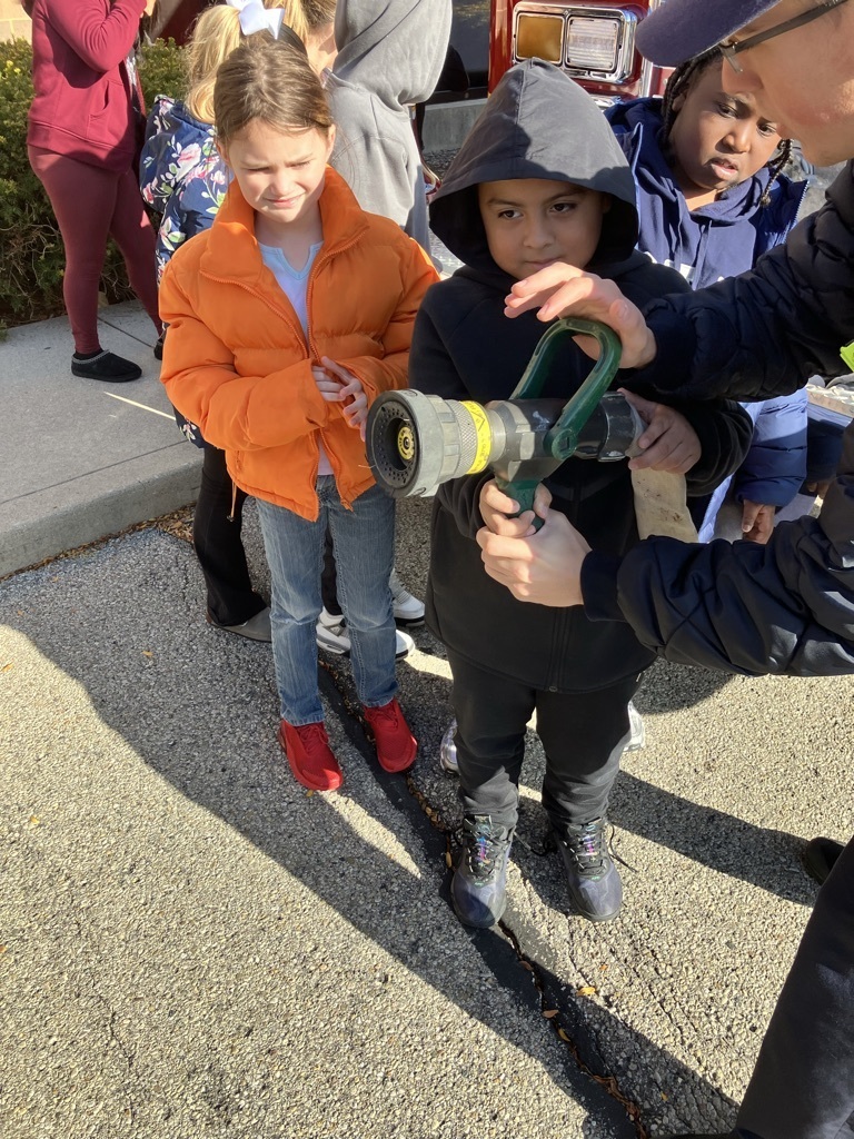 girl and boy with fire hose
