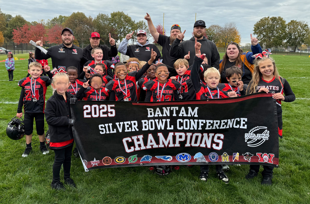 Football players, cheerleaders and coaches with champions banner