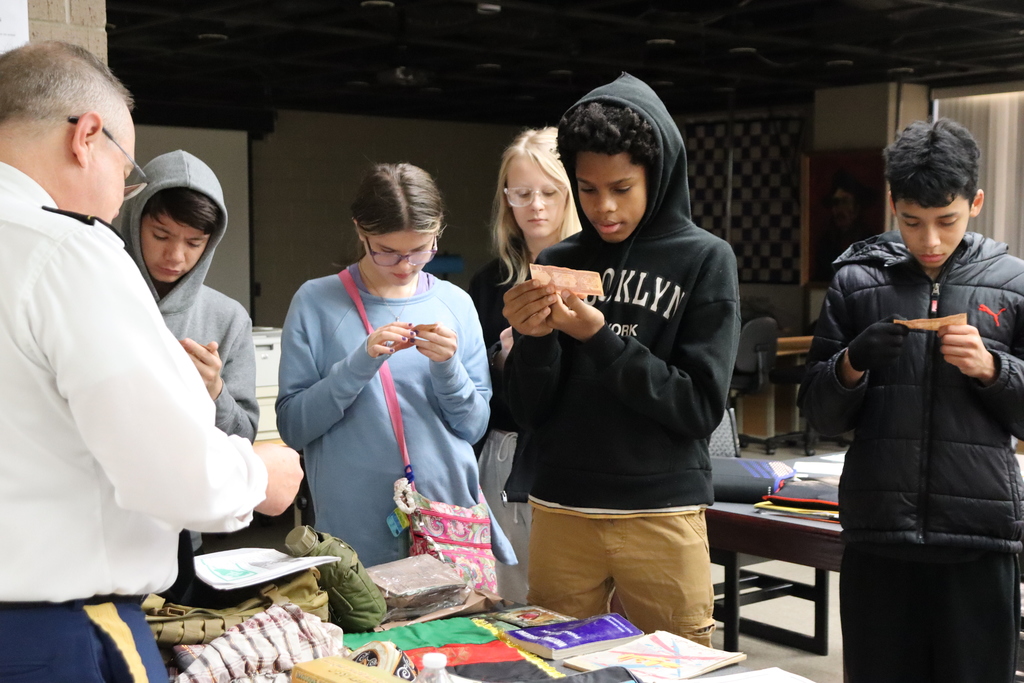 Students looking at money from a foreign country
