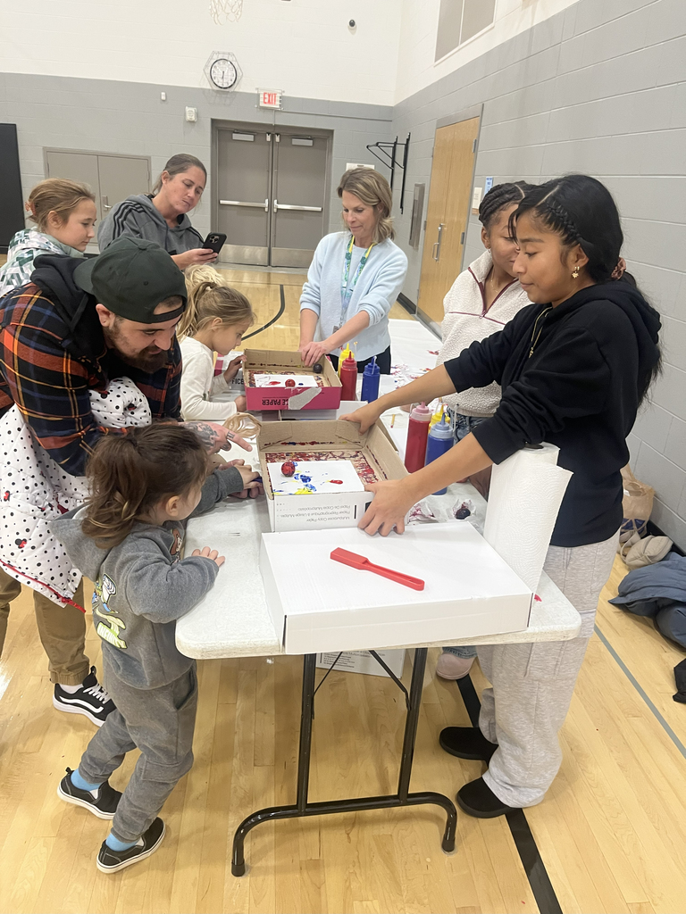 children and adults at a table during STEAM Night