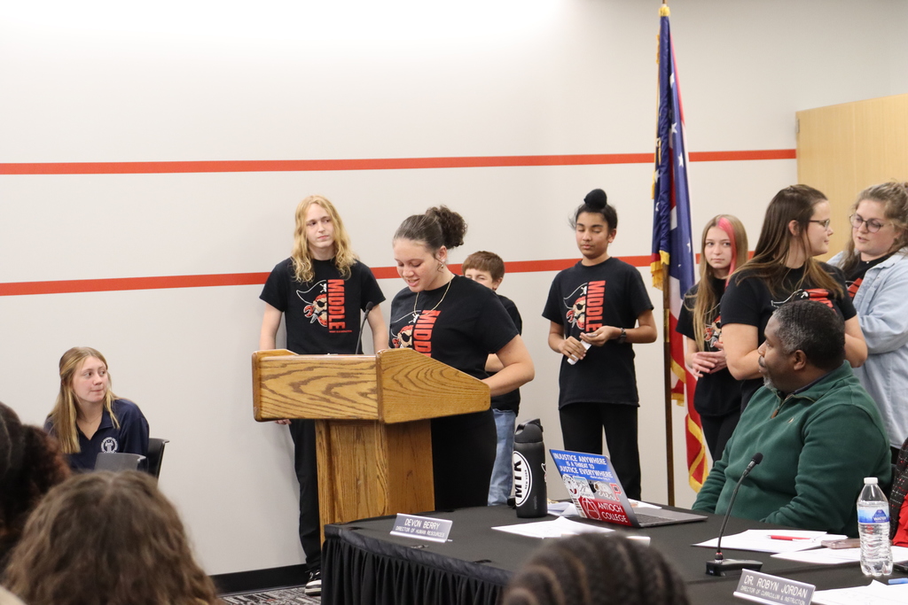 Students making a presentation at the school board meeting