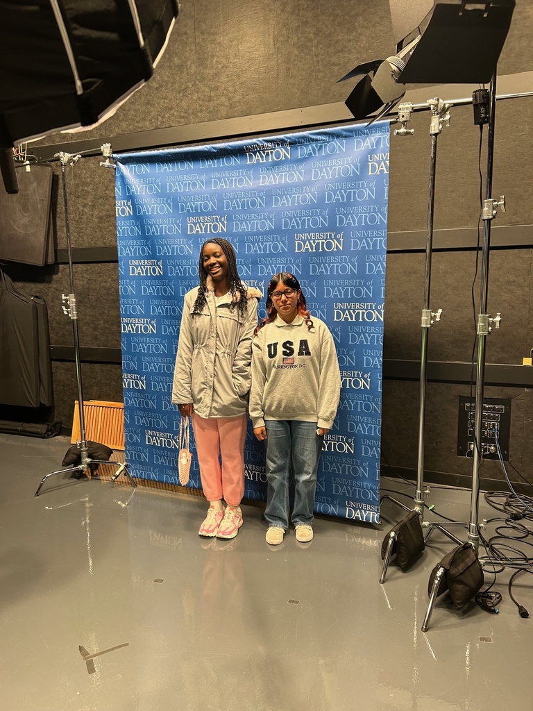 students in front of screen in news studio