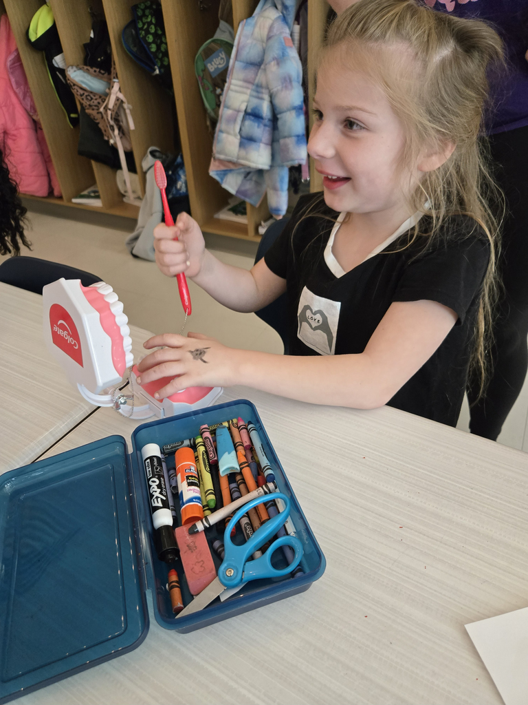 girl holding toothbrush and smiling