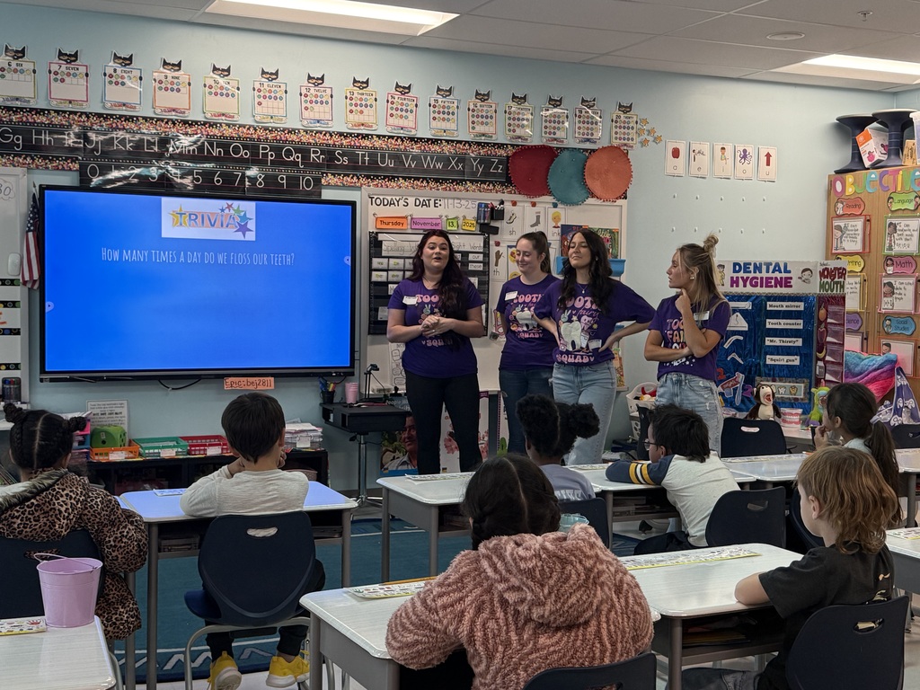 four women in front of a classroom