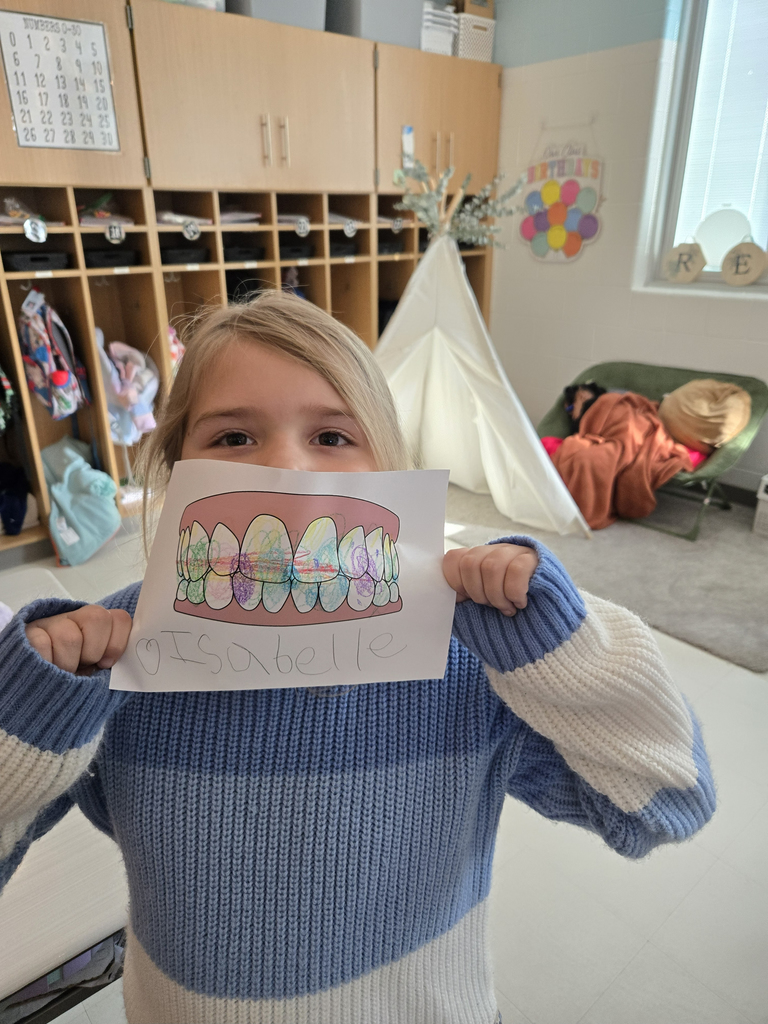 girl holding coloring sheet