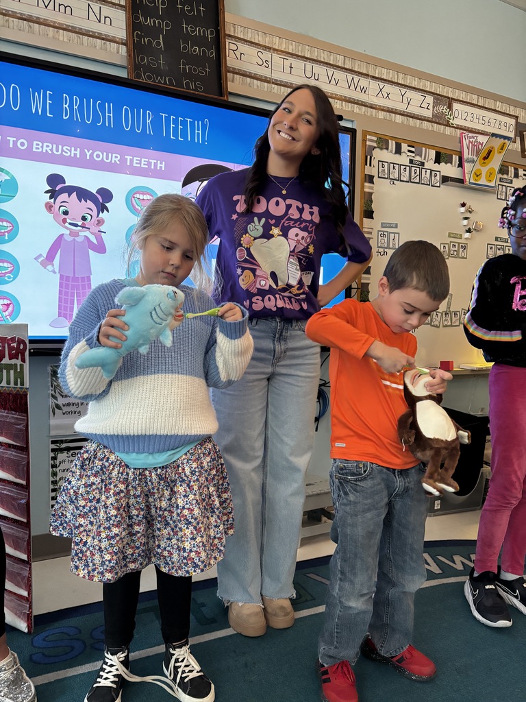 woman standing with two children