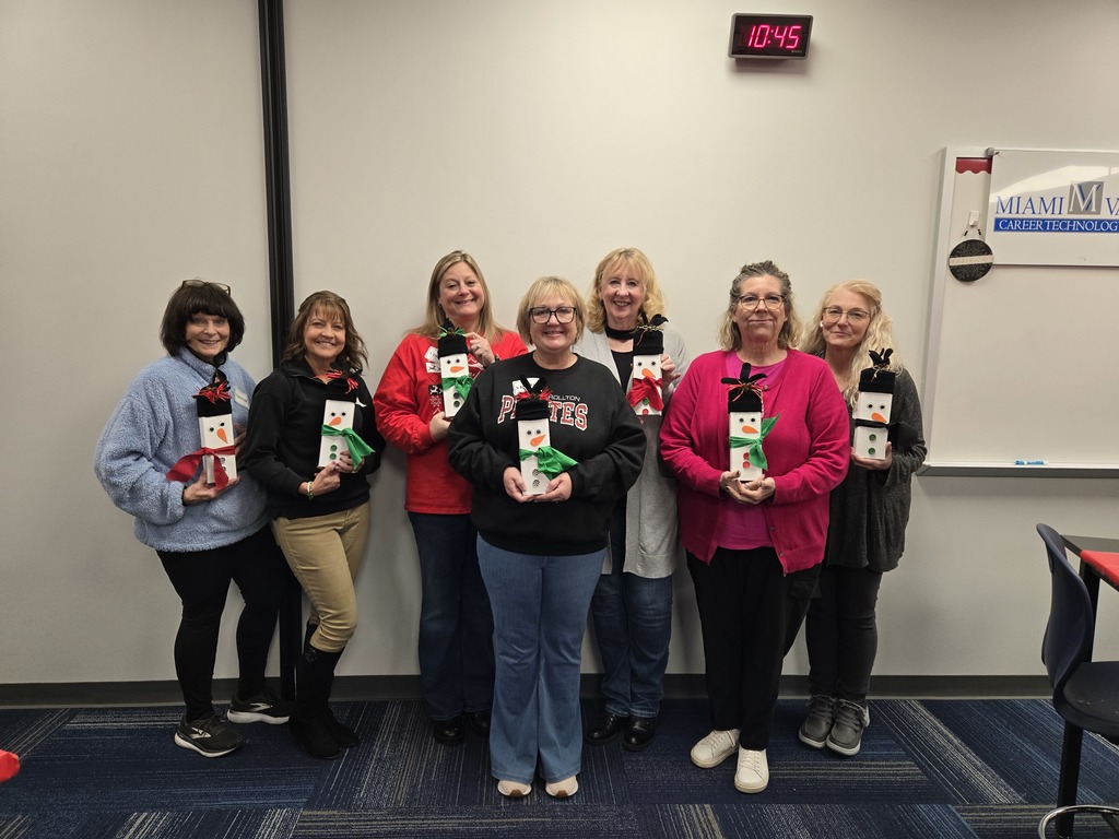 group of people holding snowmen