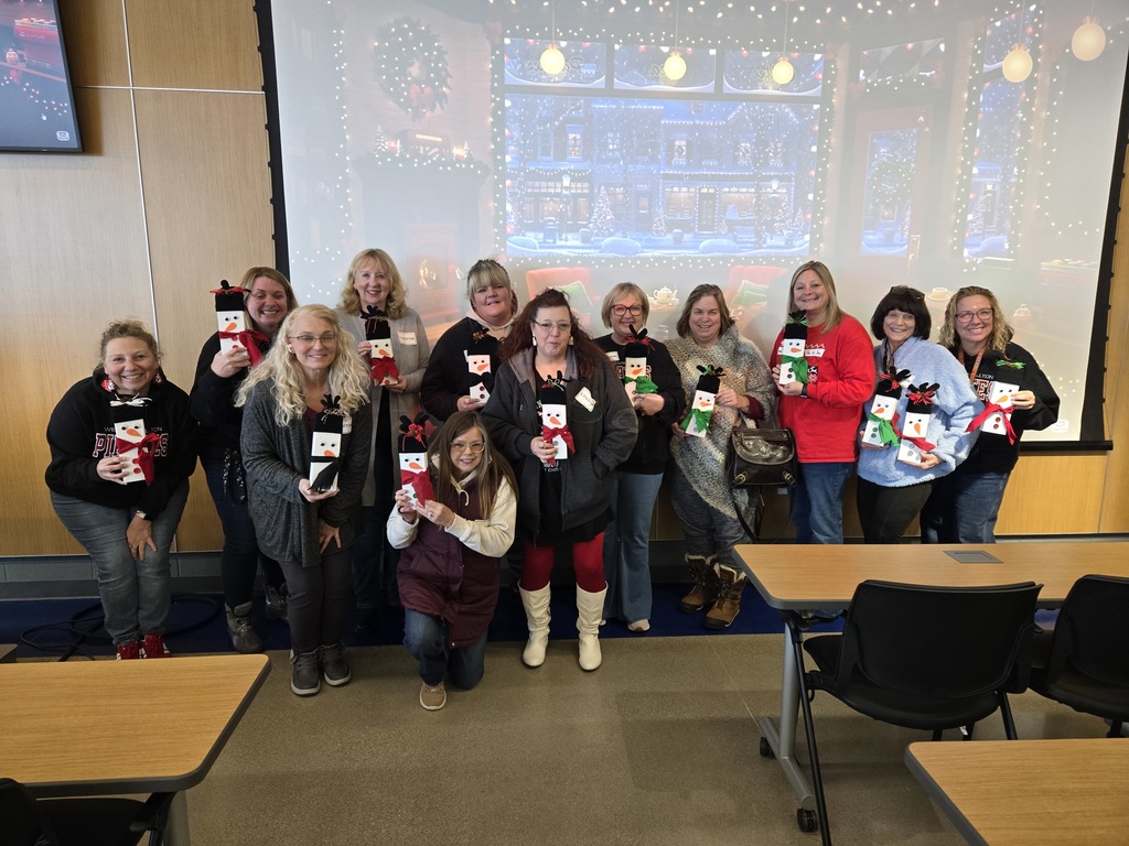 group of people holding snowmen