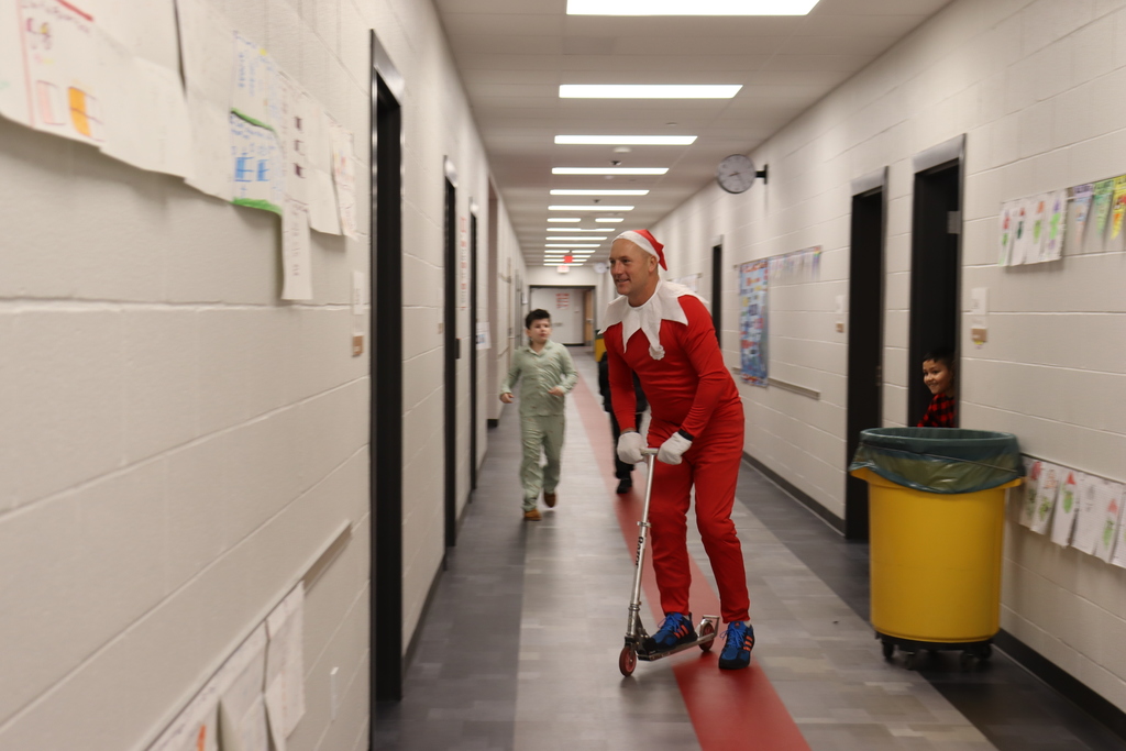man in an elf suit on a scooter