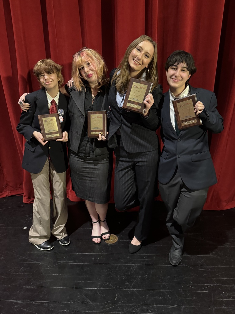 students holding plaques