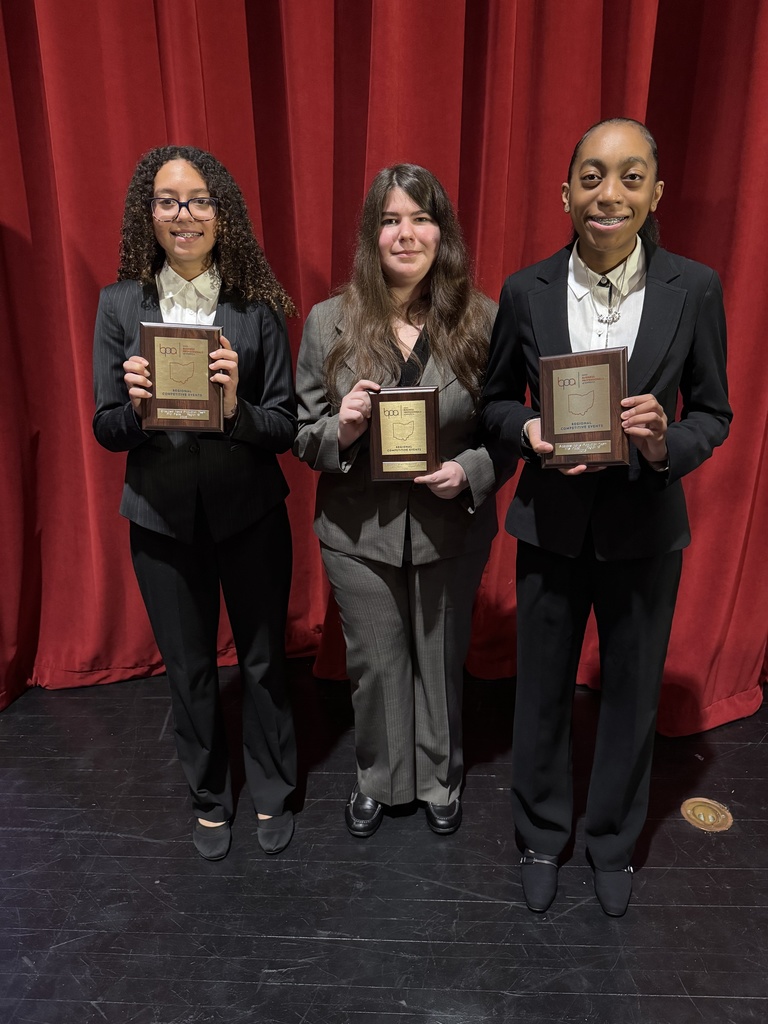 students holding plaques
