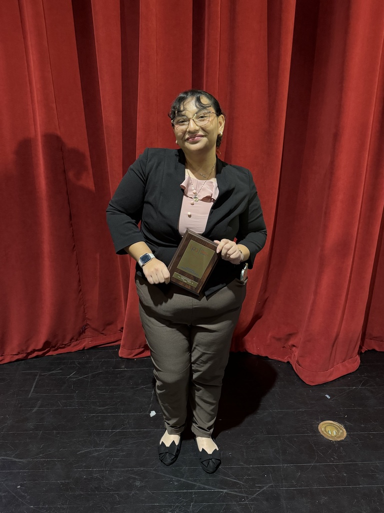 student holding plaque