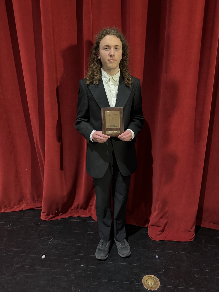 boy holding a plaque