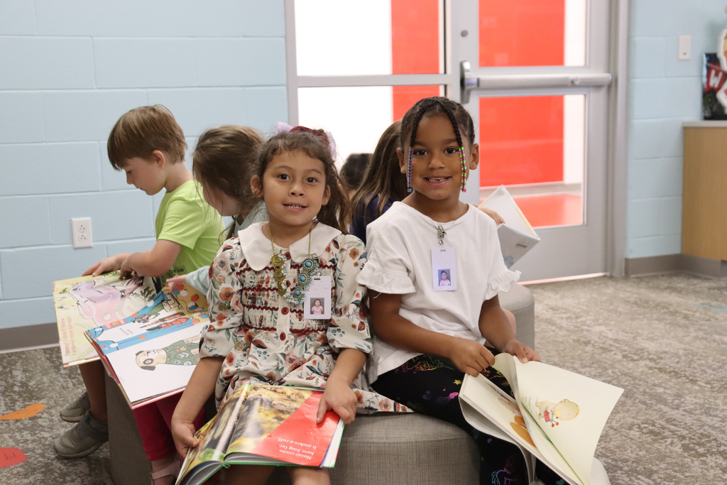 children reading books together in a school library