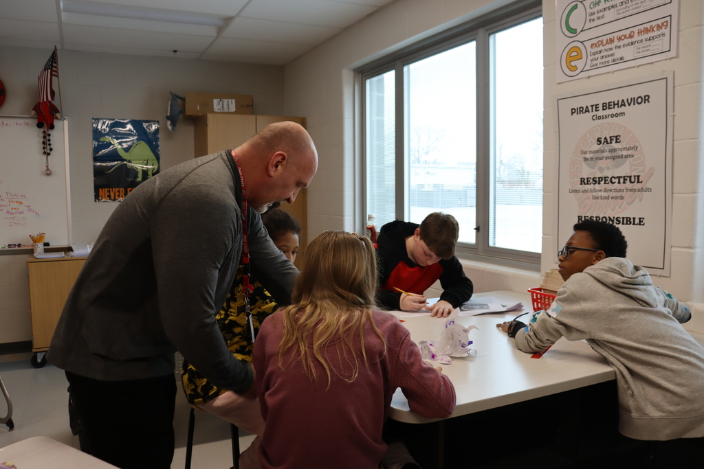 teacher helping students with science experiment