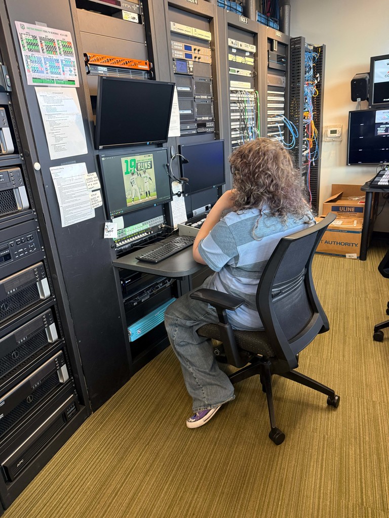 student working at a computer with a baseball program on the screen