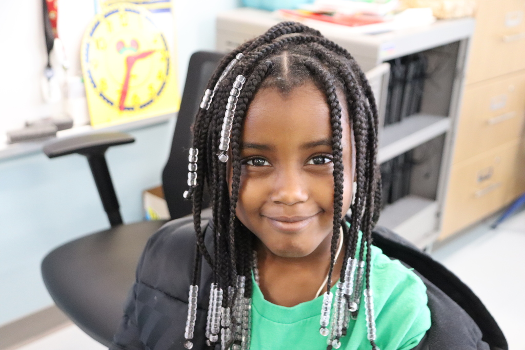 girl wearing a green shirt and smiliing