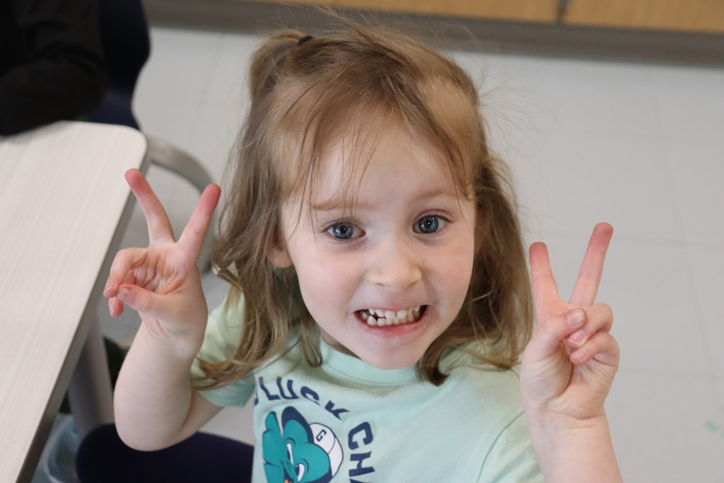girl smiling wearing a green shirt