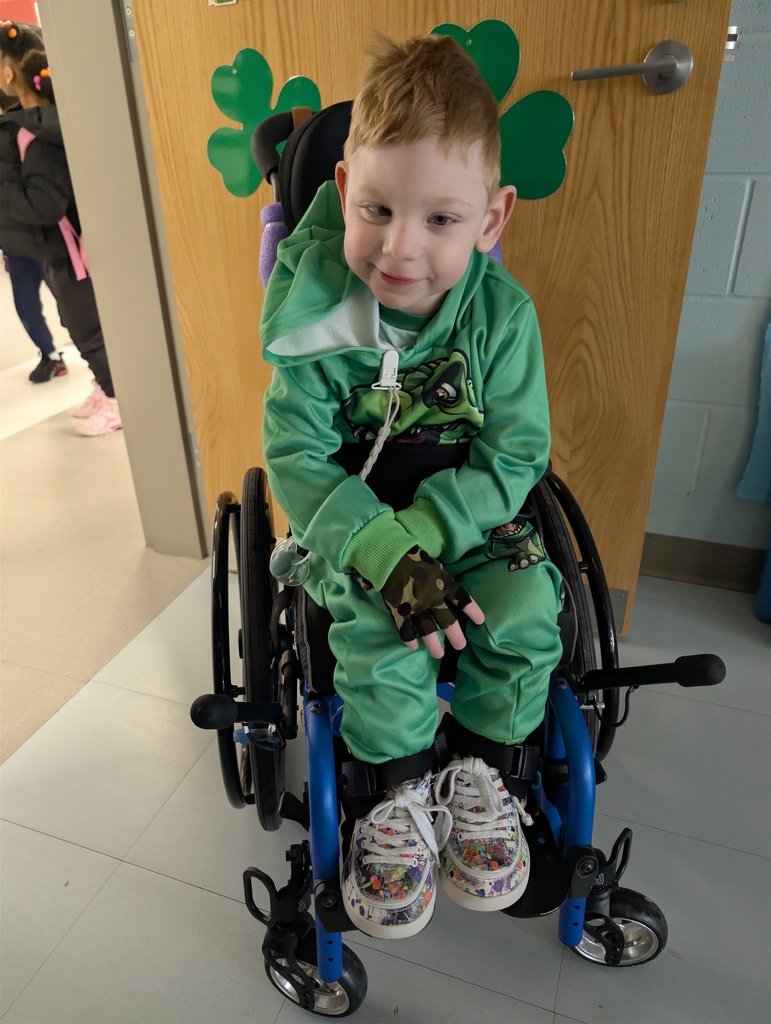 Boy in green shirt and pants