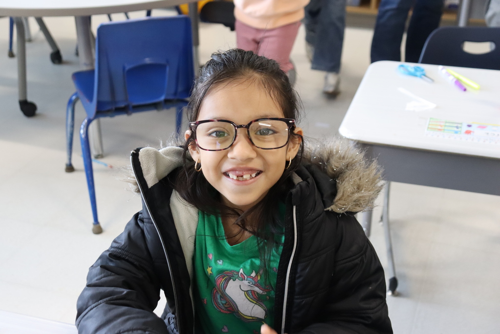 girl wearing glasses in a green shirt