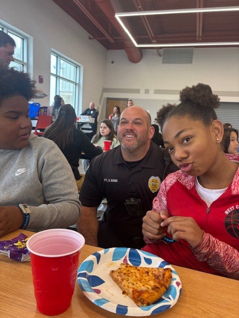 2 students having lunch with a police officer