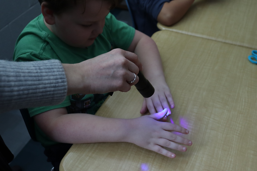 hands under a UV light
