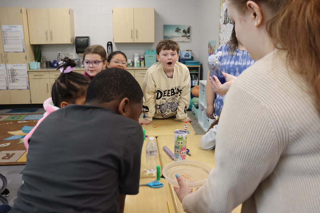 Students looking at an experiment using soap