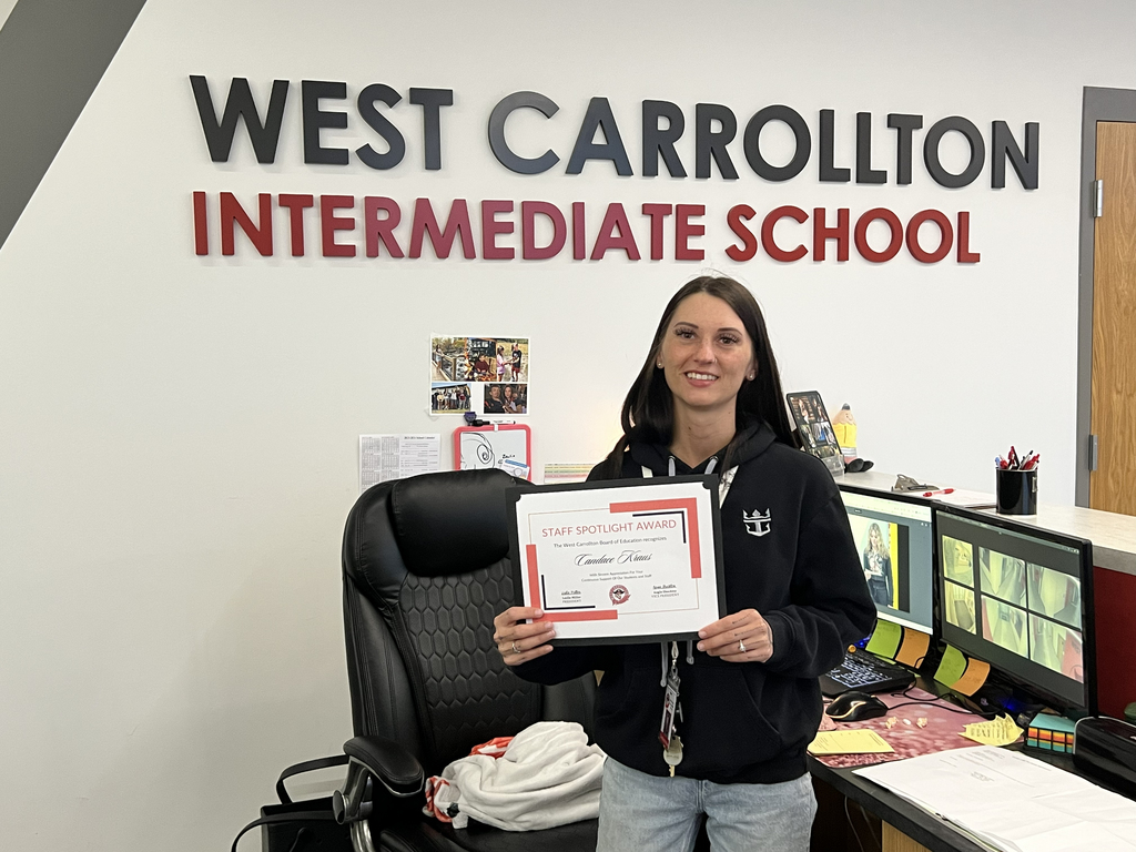 Candace Kraus holding a staff spotlight certificate